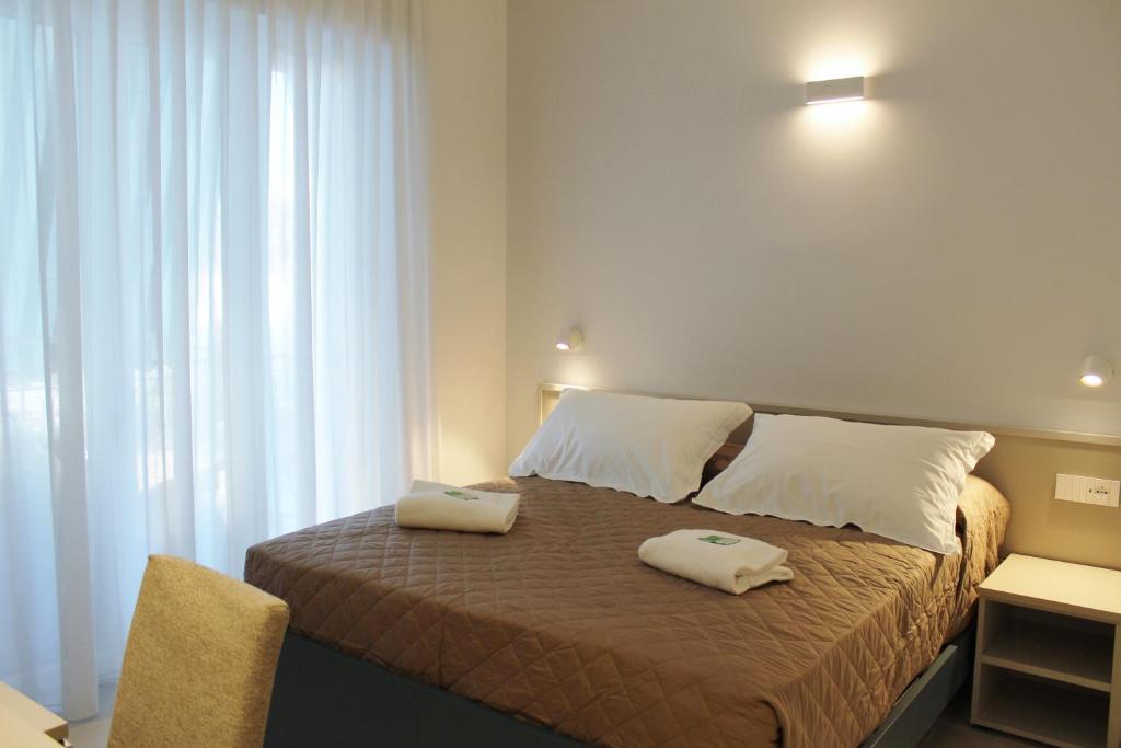 a bedroom with a bed with two towels on it at Divina Holiday - Rooms in Maiori