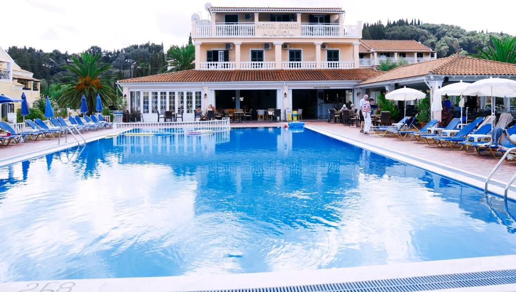 a large swimming pool in front of a building at Alkion Hotel in Sidari