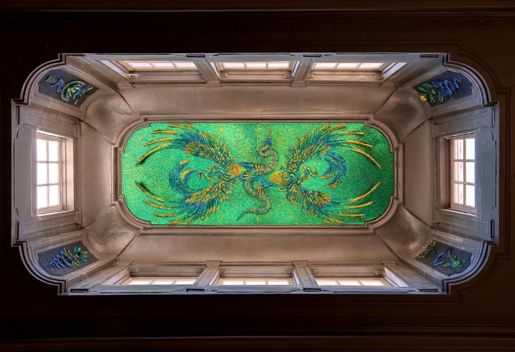 a ceiling with a painting of a peacock on it at Hôtel Richer De Belleval - Relais &amp; Châteaux in Montpellier