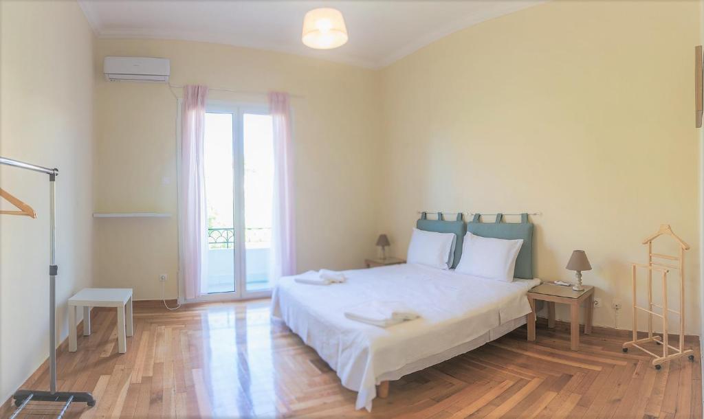a bedroom with a large bed and a large window at The Athenian House -Duxiana bed in Athens