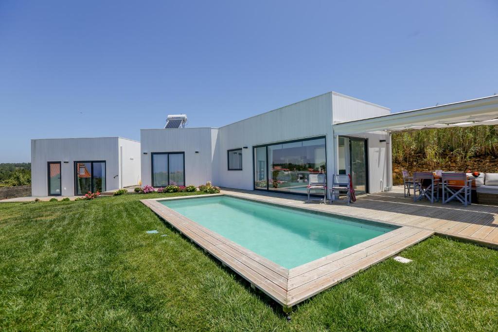a house with a swimming pool in the yard at Like-home-T2 house, pool, AC, garden in Ericeira