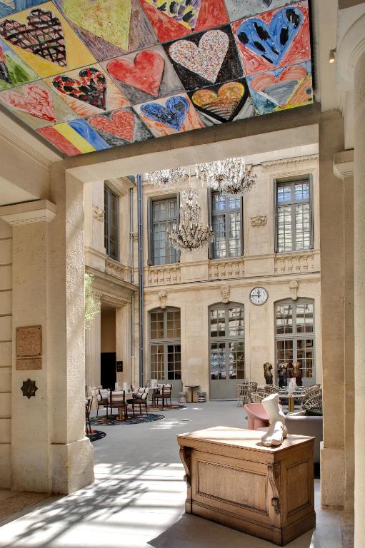 a large building with a large painting on the ceiling at Hôtel Richer De Belleval - Relais &amp; Châteaux in Montpellier