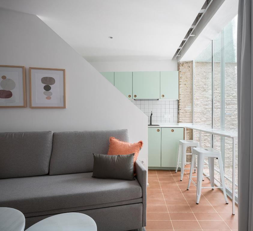 sala de estar con sofá y cocina en Don Fadrique Apartments by Olala Homes en Sevilla