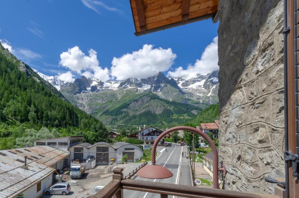 a view from a balcony of a town with mountains at Chalet Pontal 6 in Courmayeur