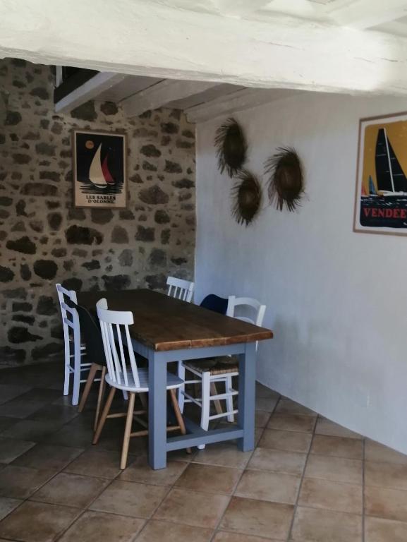 a blue table and chairs in a room at Le cottage de l&#39;étang in Le Tablier