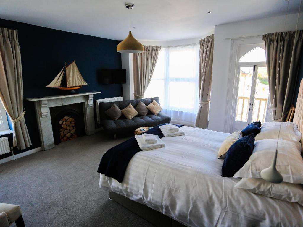 a bedroom with a large bed and a couch at The Smugglers Rest in Woolacombe