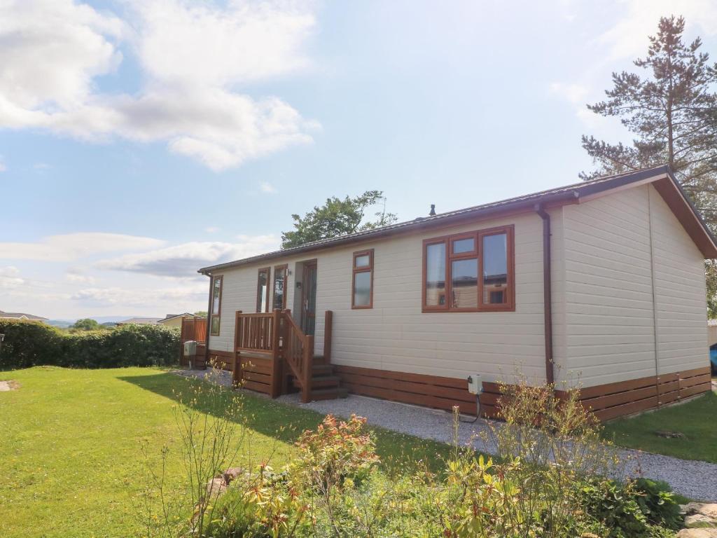 a tiny house with a porch and a yard at 9 Pen y Ghent in Skipton