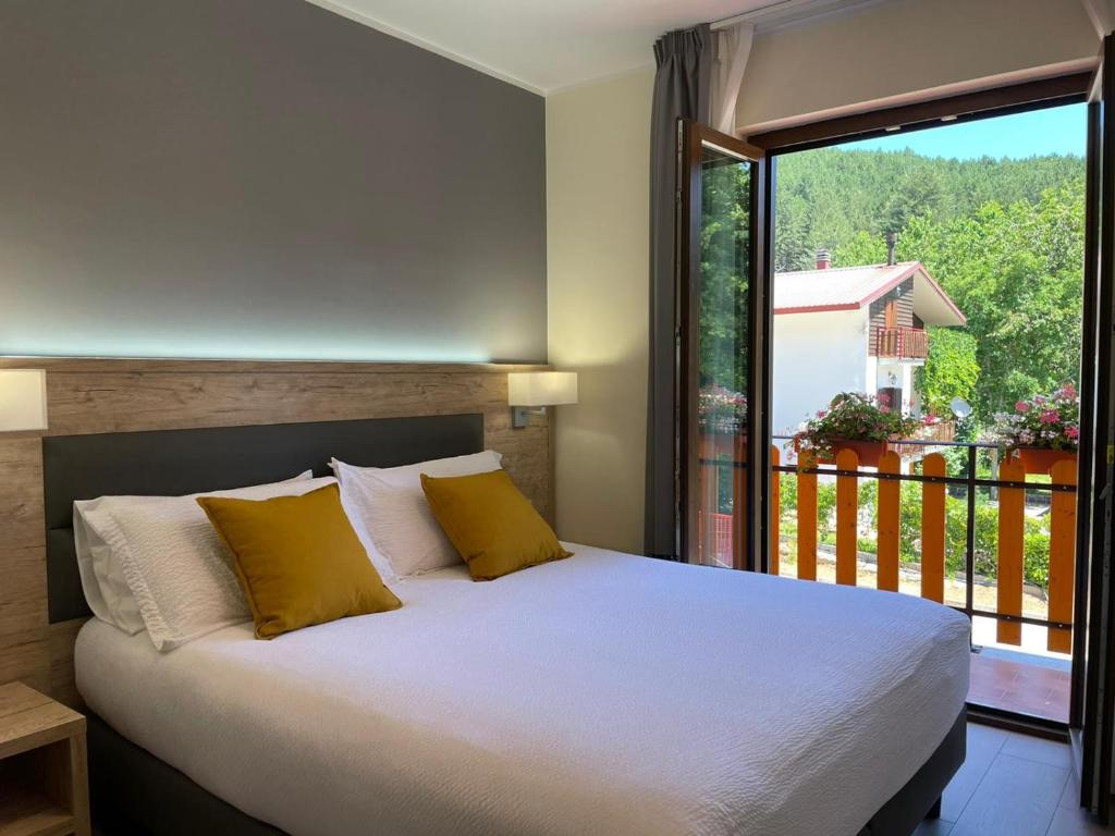 Postel nebo postele na pokoji v ubytování Arvo Residence Sila Lorica