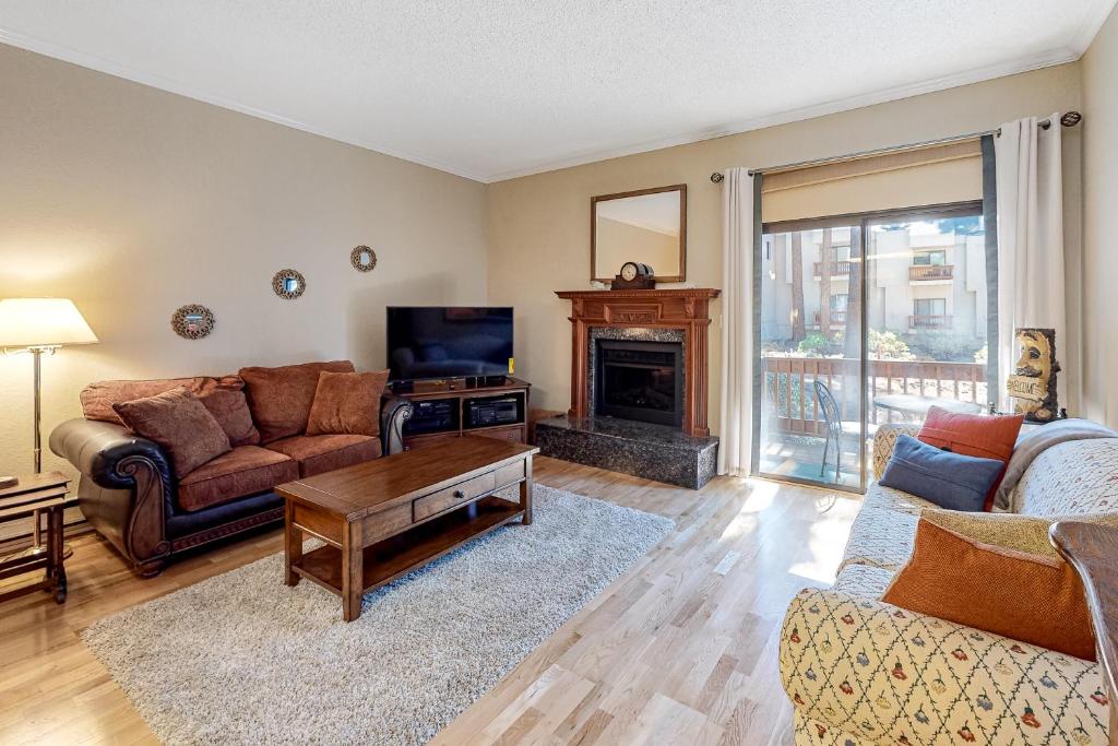 a living room with a couch and a fireplace at Tahome & Tahoe Place in Incline Village