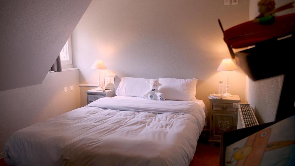 Postel nebo postele na pokoji v ubytování Les Loges de l'Ecomusée D'Alsace