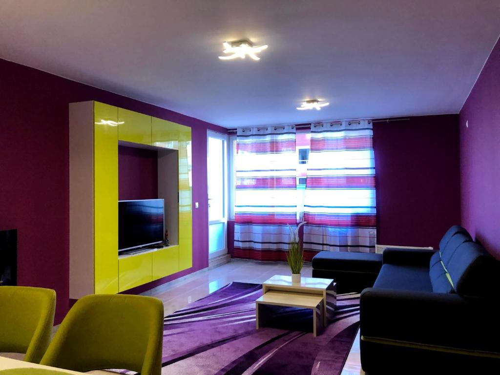 a living room with a couch and a tv at Ultraviolet relax apart in Sofia