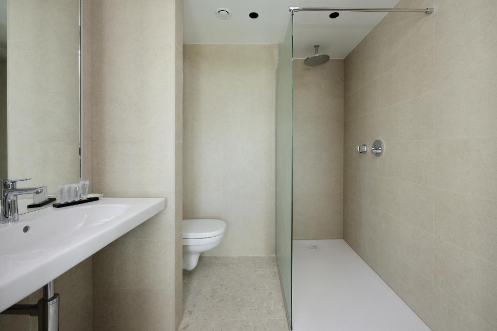 a bathroom with a toilet and a sink and a shower at Parkhotel Waregem in Waregem