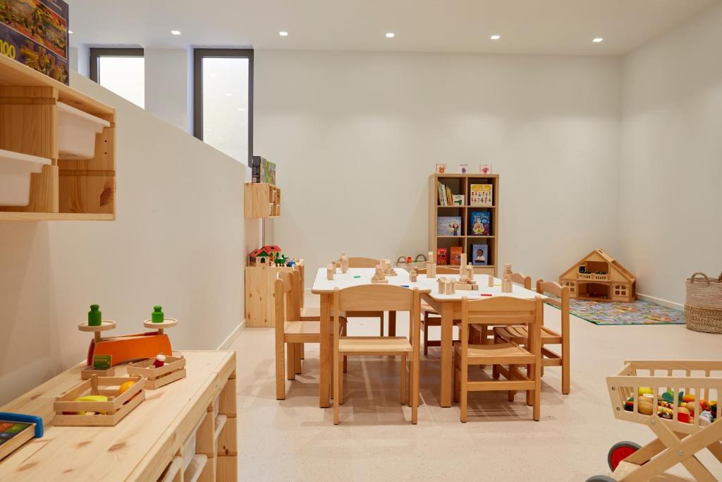 a dining room with a table and chairs at Elix, Mar-Bella Collection in Perdika