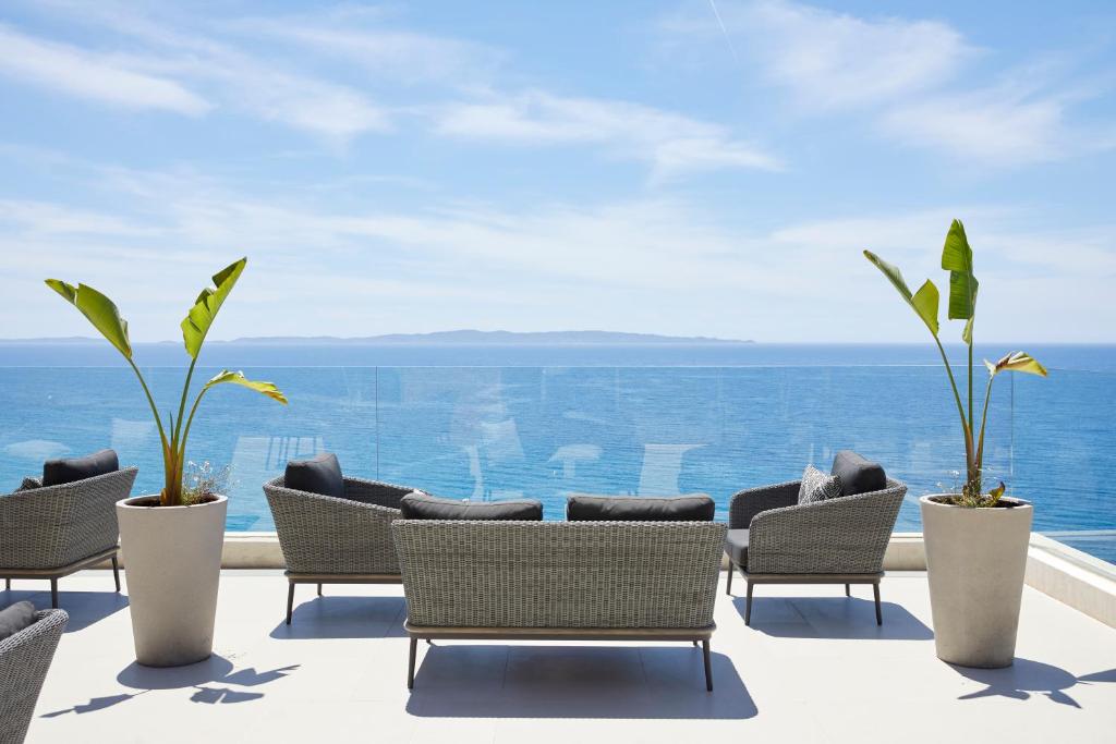 a patio with chairs and a view of the ocean at Elix, Mar-Bella Collection in Perdika
