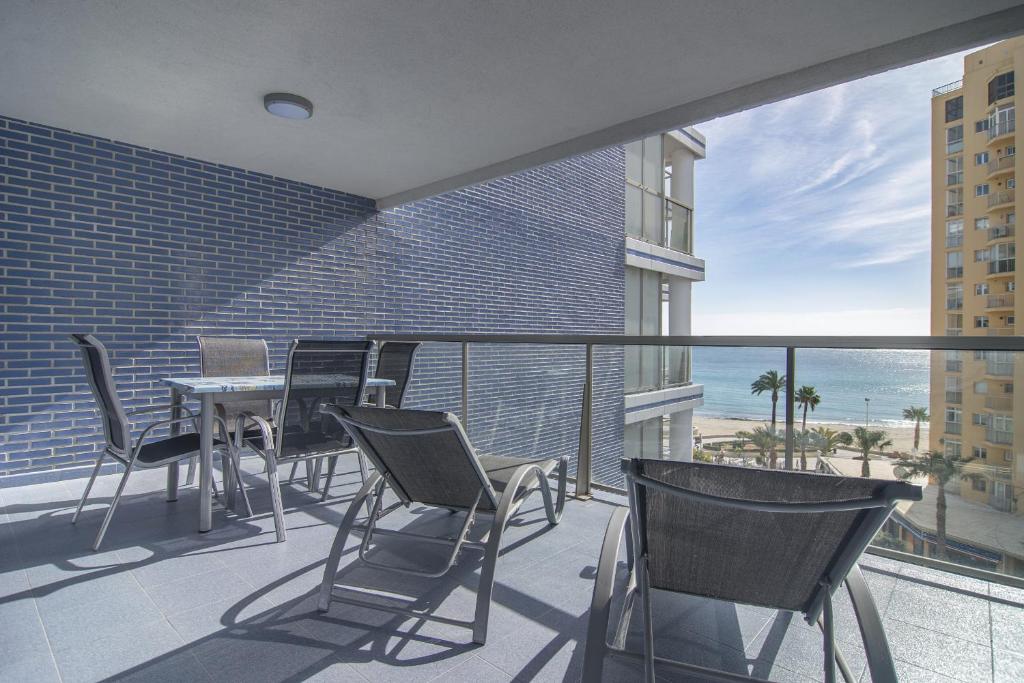 a balcony with a table and chairs and the ocean at Apartamentos Hipocampos Calpe Rent Apart in Calpe