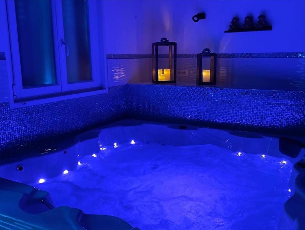 a bathroom with a tub with lights in it at Villa avec maxi Jacuzzi aux Portes de Paris in Arcueil