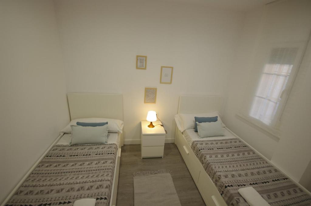 Posteľ alebo postele v izbe v ubytovaní Livingtarifa Apartamento Coco