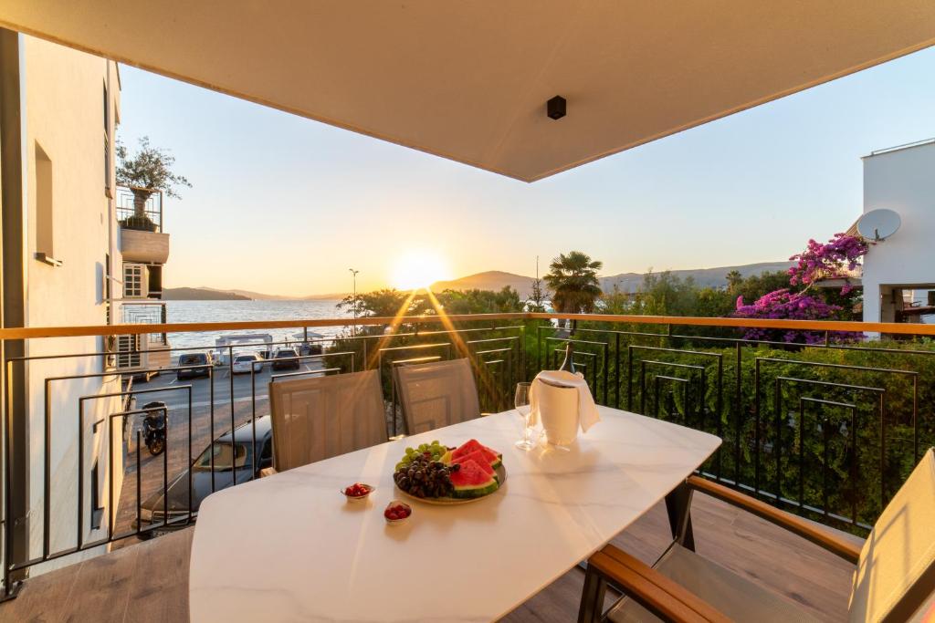 a table with a plate of food on a balcony at Luxury apartment Vagabundo 1 Free parking in Trogir