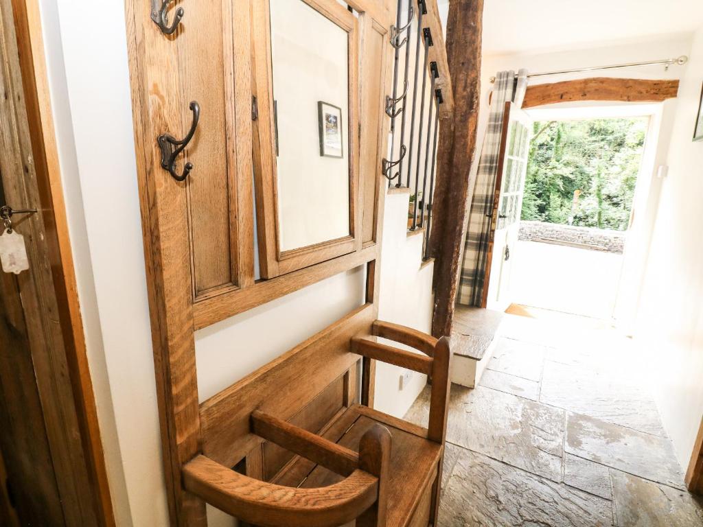 a wooden door in a room with a stairway at The Barn in Buxton
