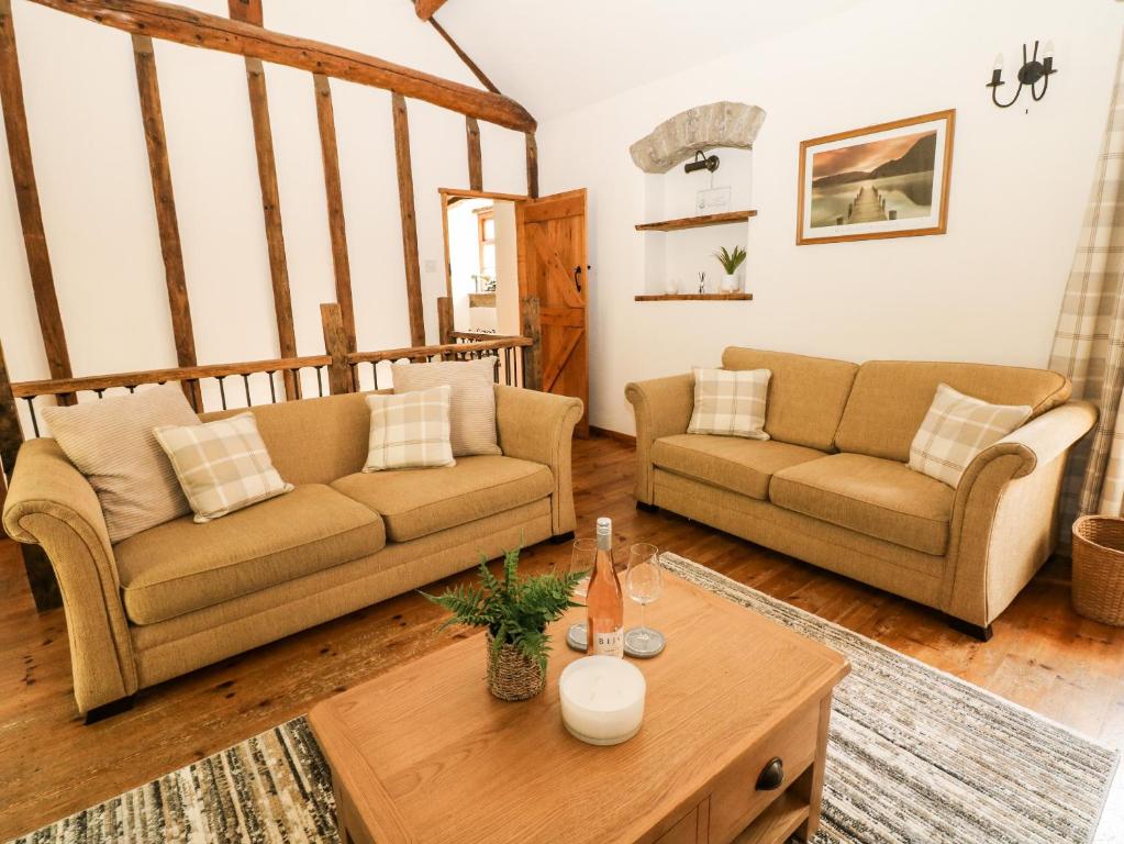 a living room with two couches and a coffee table at The Barn in Buxton