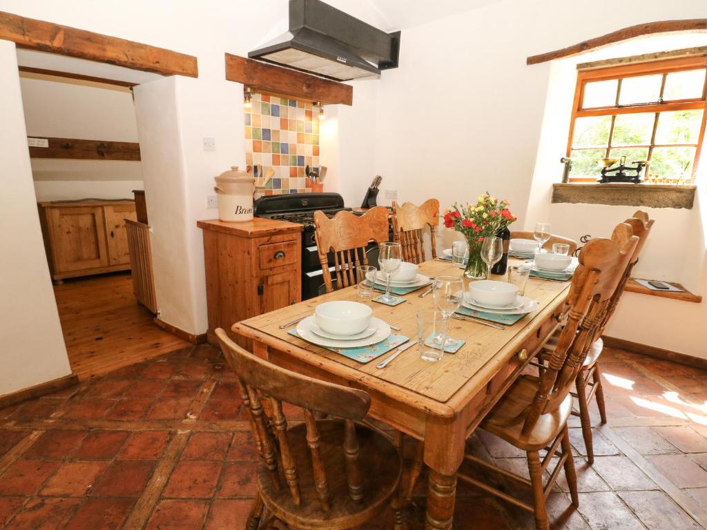 a dining room with a wooden table and chairs at The Barn in Buxton
