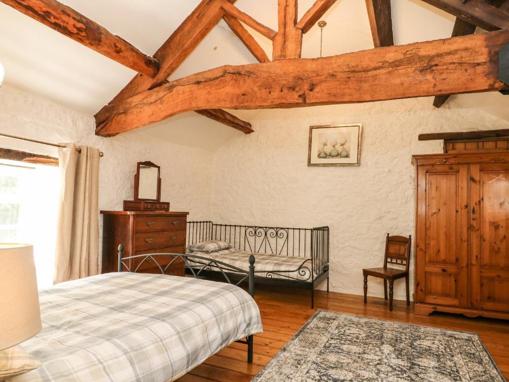 a bedroom with a bed and a dresser at The Barn in Buxton