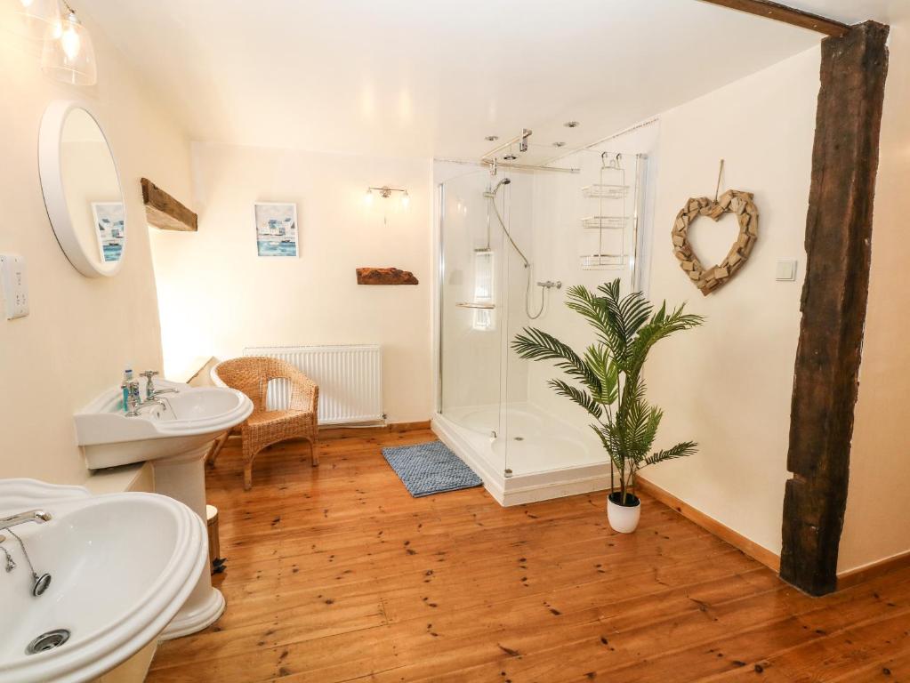a bathroom with a shower and a toilet and a sink at The Barn in Buxton