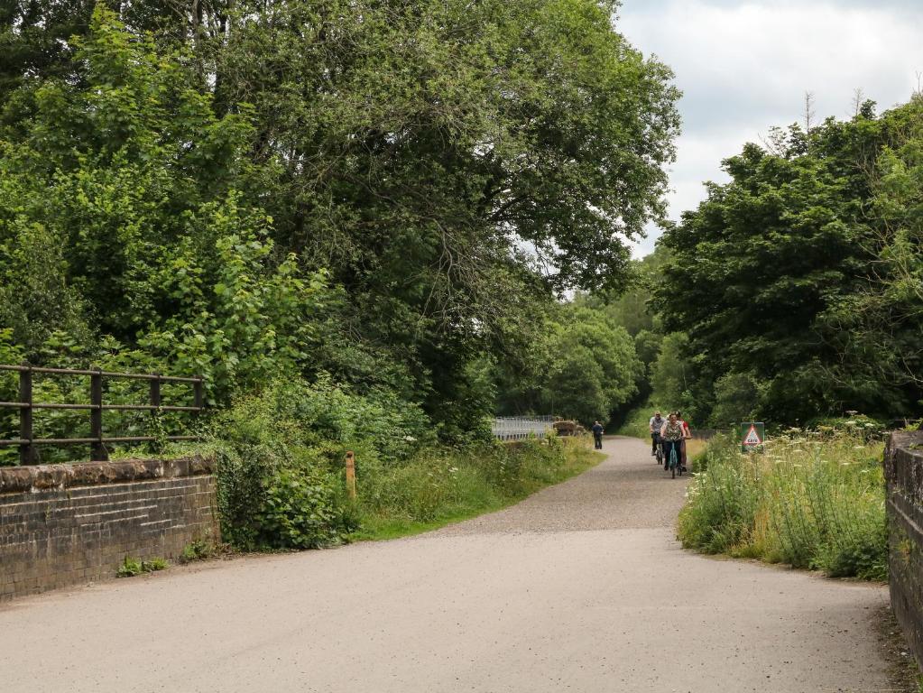 a group of people riding bikes down a dirt road at The Barn in Buxton