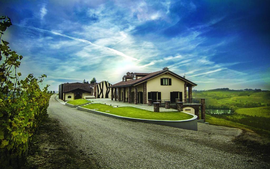 une maison sur le côté d'une route dans l'établissement Montalbera Wine Suites, à Montemagno