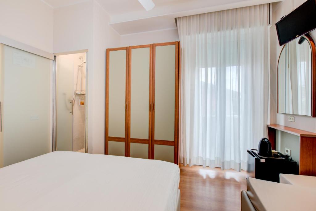 Postel nebo postele na pokoji v ubytování Hotel Sympathy