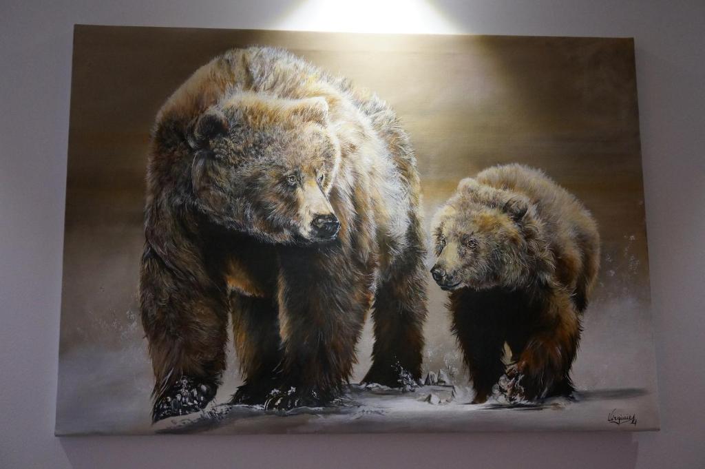 a painting of two bears walking in the snow at Apartament Montagne in Zakopane