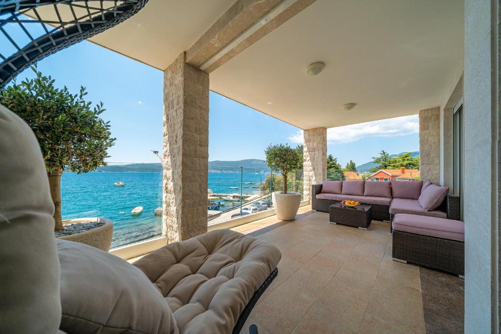 a living room with a view of the ocean at Elysium Tivat in Tivat