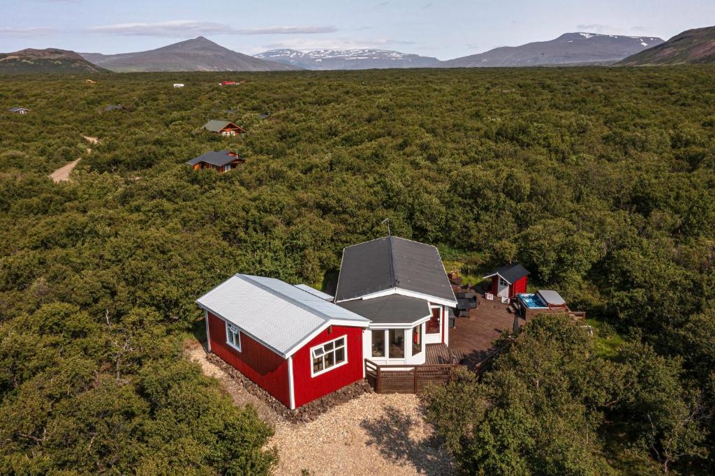 an aerial view of a red house in a field at Húsafell holiday homes in Húsafell