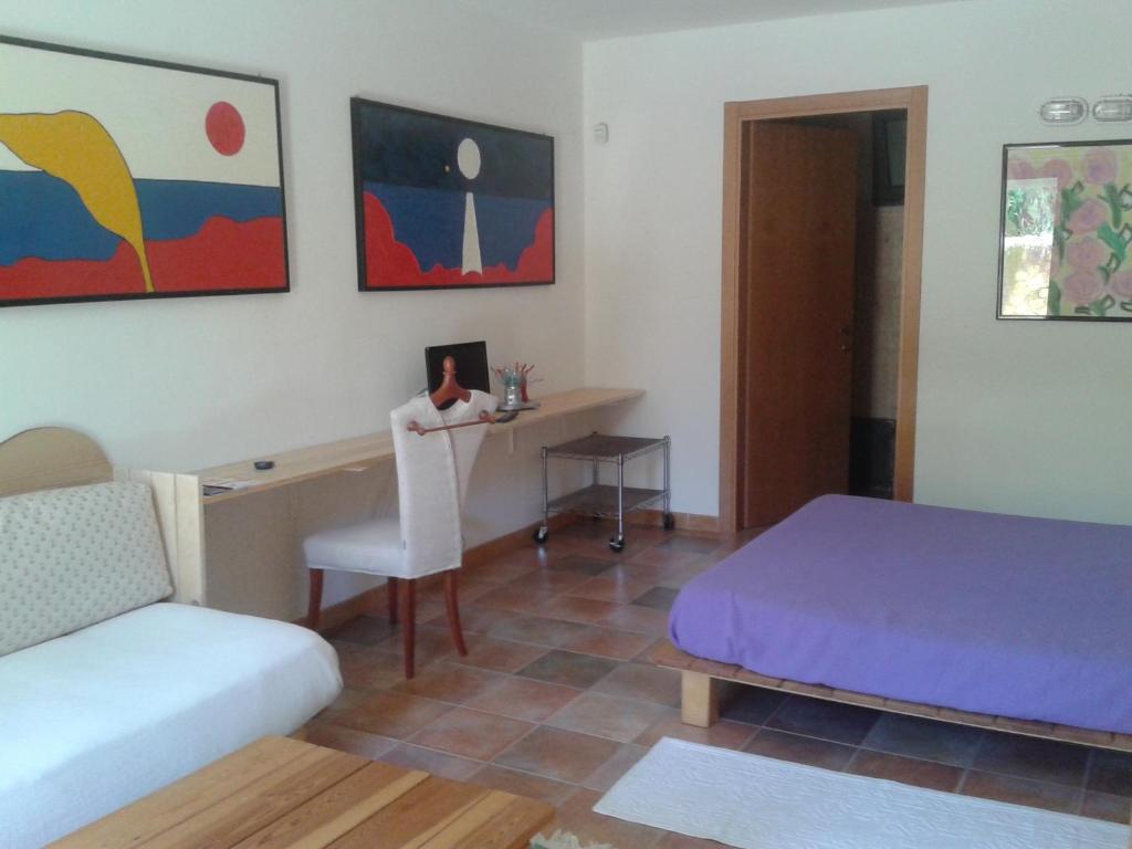 a bedroom with a desk and a bed and a chair at Il Locandiere in Capitana