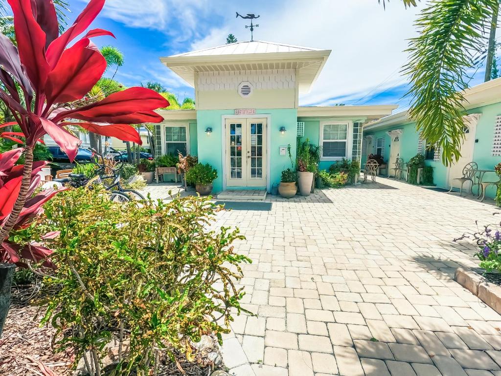 a house that has a patio and some plants at Haley's at Anna Maria Island Inn in Holmes Beach