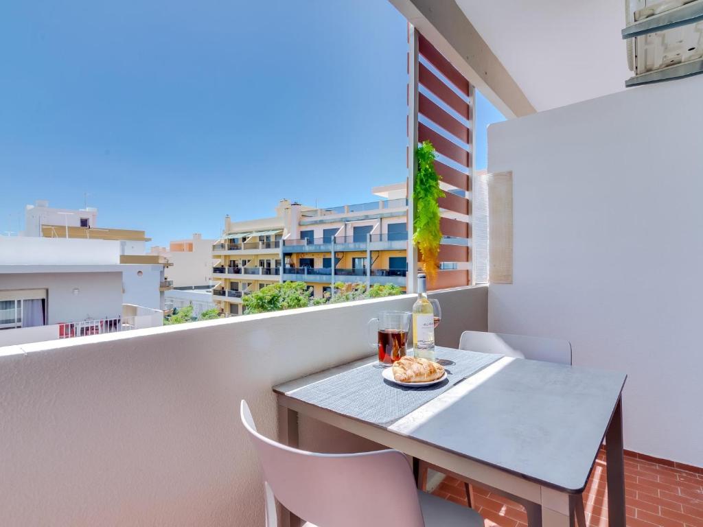 a table and chairs on a balcony with a view at AL - Apartamento Miratlântico in Quarteira
