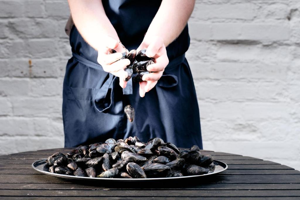 a person is standing next to a plate of food at The Ship At Dunwich in Dunwich