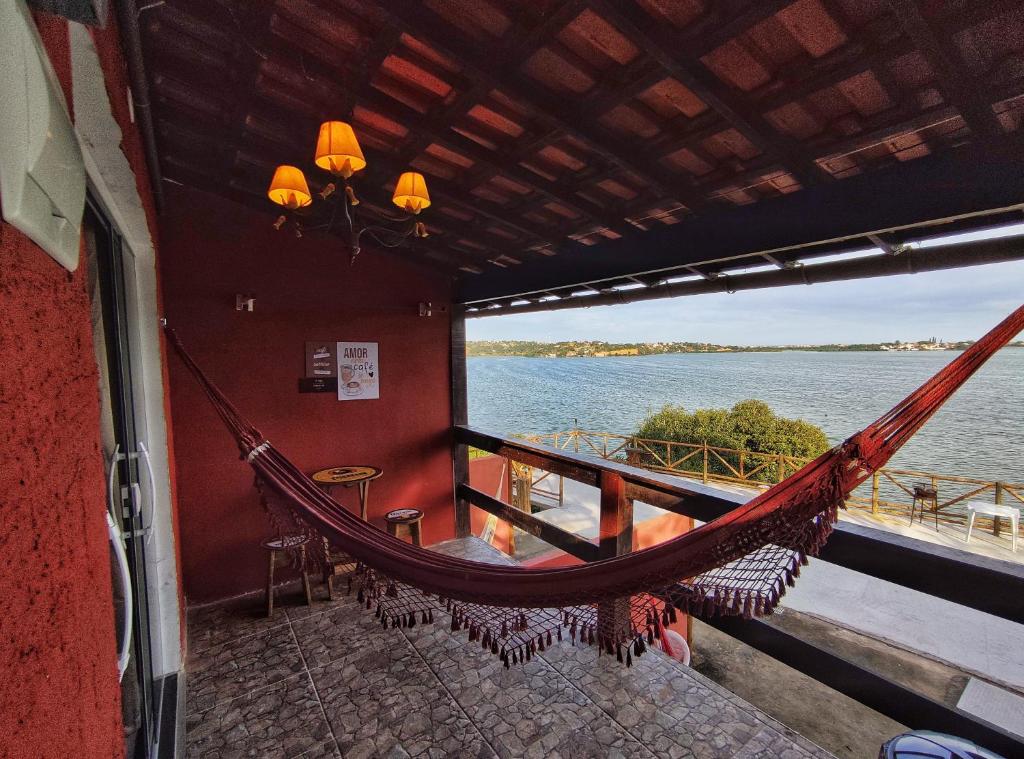 a hammock on a boat with a view of the water at Pousada Bela Vista Maricá in Maricá