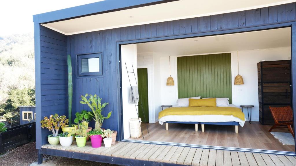 a bedroom with a bed on a deck at Palcos de Apalta in Santa Cruz