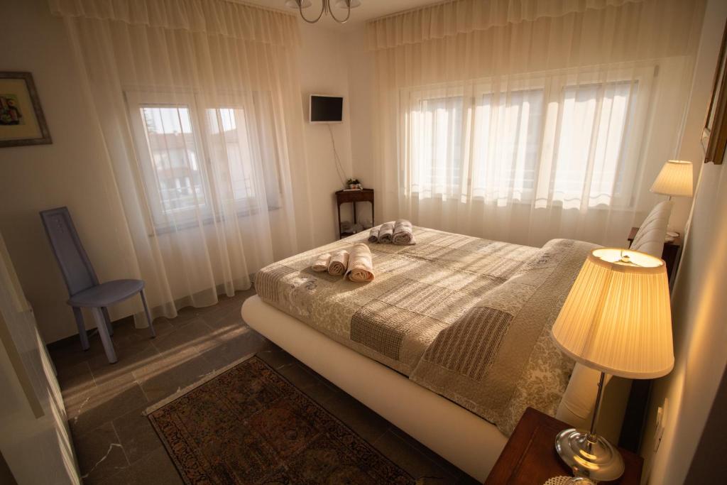 a bedroom with a bed with two towels on it at Bed Adelaide in Cividale del Friuli