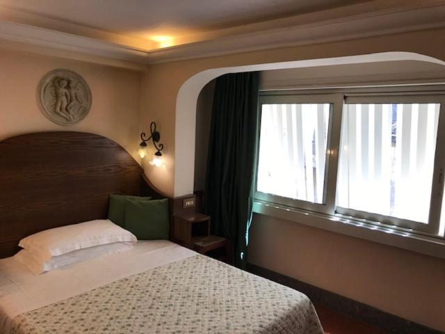 Postel nebo postele na pokoji v ubytování Hotel OKAPI