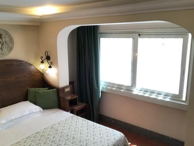 Postel nebo postele na pokoji v ubytování Hotel OKAPI