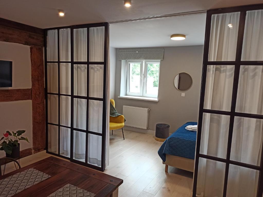 um quarto com uma cama e uma porta de vidro deslizante em Mieszkanie w Kamienicy 4C em Pasłęk