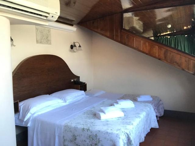 Postel nebo postele na pokoji v ubytování Hotel OKAPI