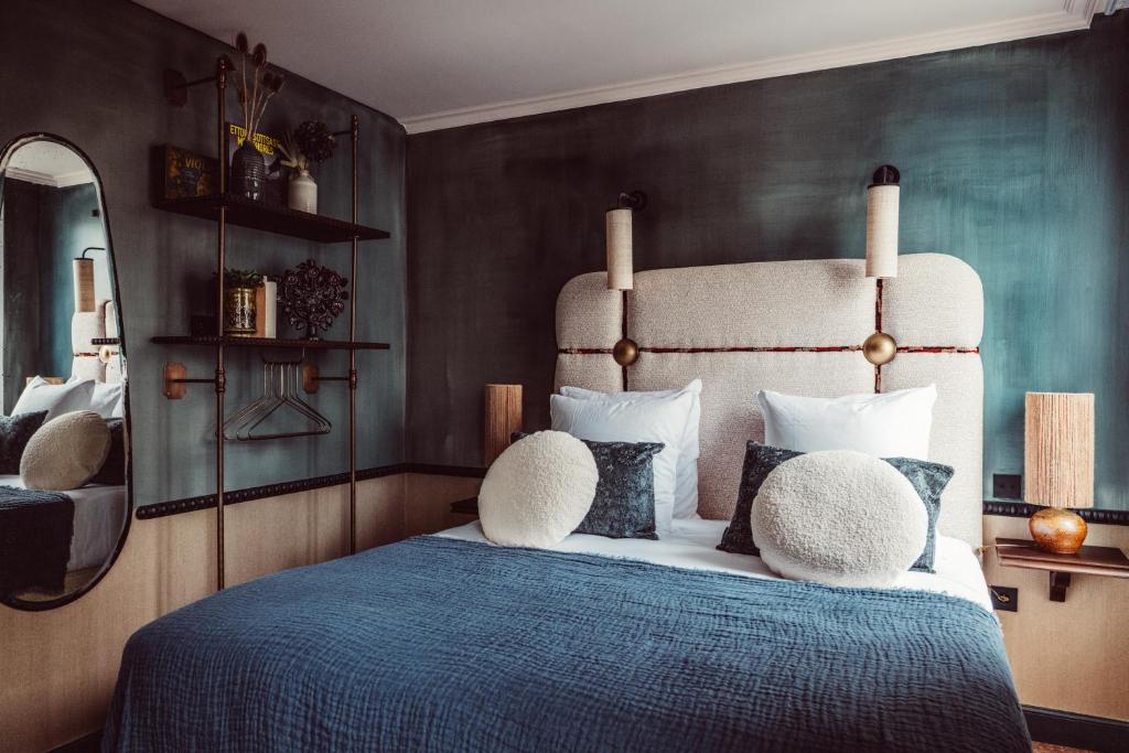 um quarto com uma cama com um edredão azul em Babel Belleville em Paris