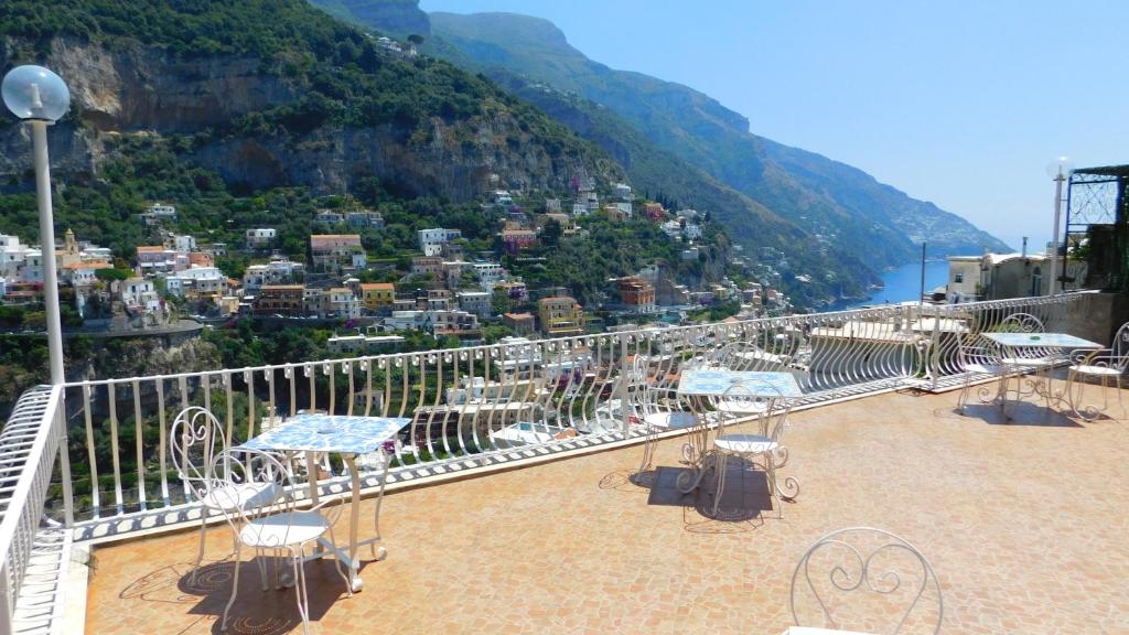
a beach filled with lots of beach chairs and umbrellas at Villaverde in Positano
