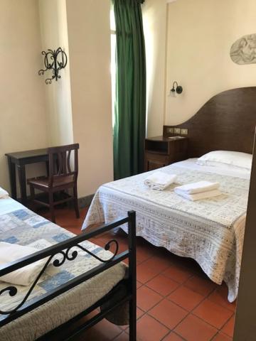 Postel nebo postele na pokoji v ubytování Hotel OKAPI