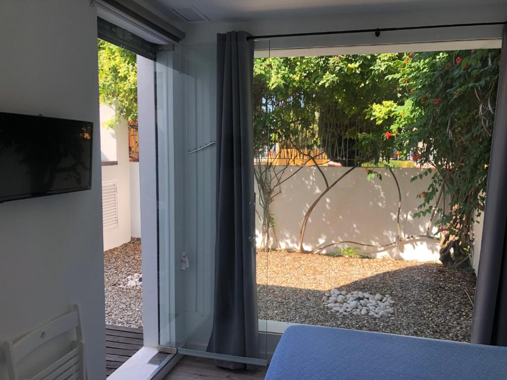 a sliding glass door with a view of a yard at La Estación in Sanlúcar de Barrameda