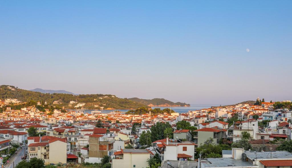 a view of a city with houses and the ocean at Antonia House in Skiathos