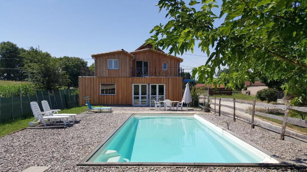 a house with a swimming pool in front of it at Périgord Curiosités in Coux-et-Bigaroque